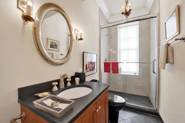 a bathroom with a sink a toilet and a mirror