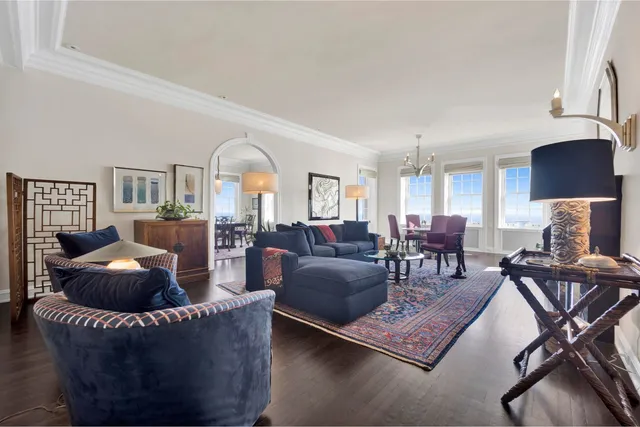 a living room with furniture and a lamp