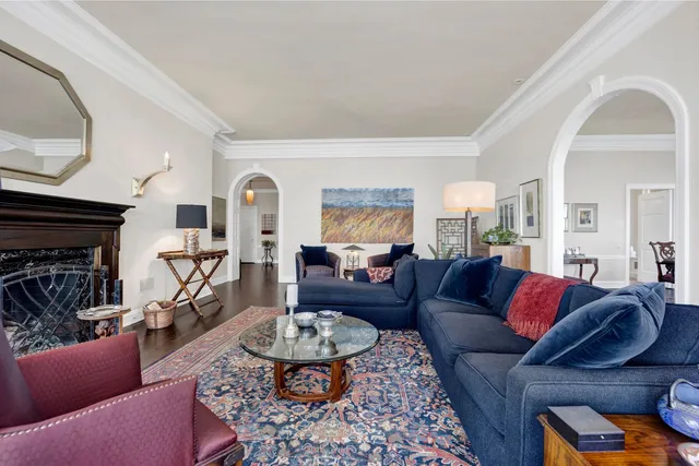 a living room with furniture fireplace and a table