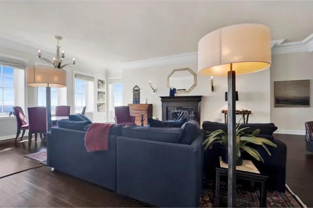a living room with furniture a flat screen tv and kitchen view