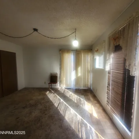a view of a livingroom with a ceiling fan and window