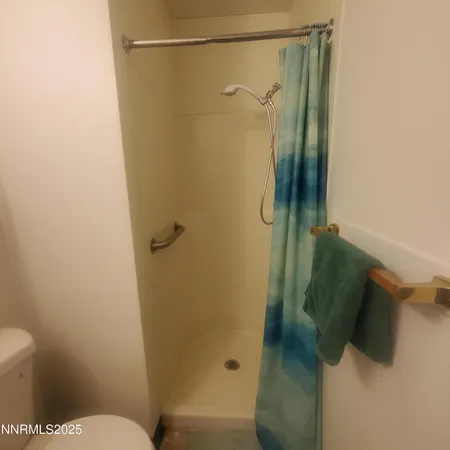 a bathroom with a shower and toilet
