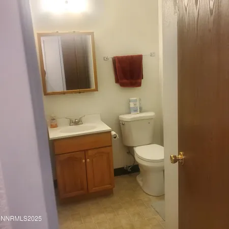 a bathroom with a toilet sink and mirror