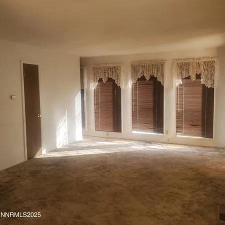 a view of a room with large windows and cabinet