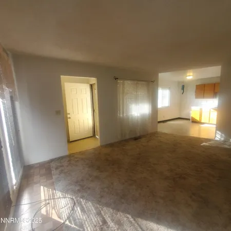 a view of wooden floor and windows in a room