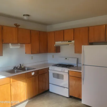 a kitchen with a sink a stove and refrigerator