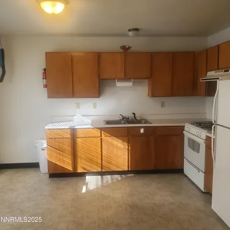 a kitchen with stainless steel appliances granite countertop a sink a stove and a refrigerator