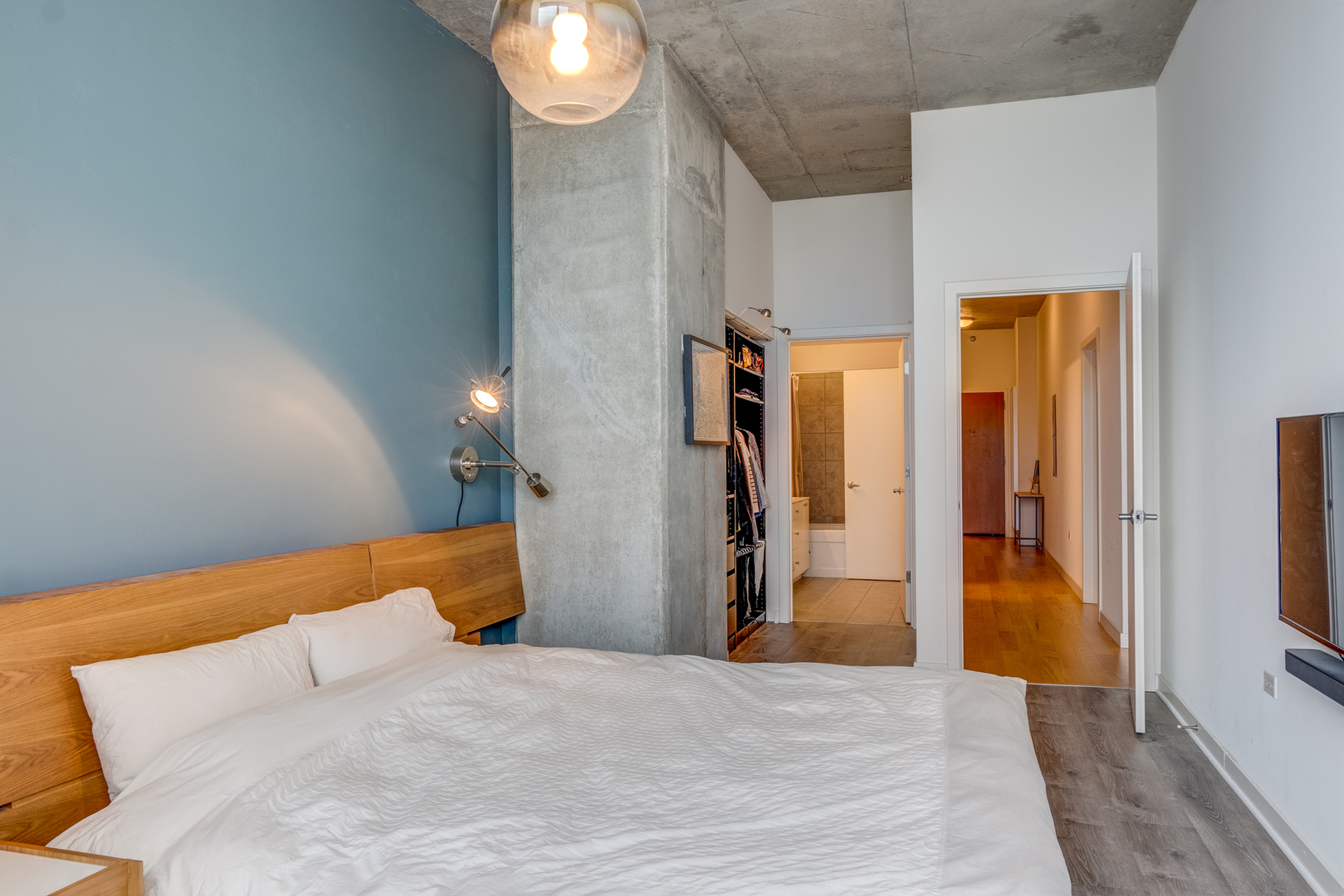 235 West Van Buren Street, Unit 3011 Chicago, IL 60607 - Photo 19 of 30 a bedroom with a bed and a mirror
