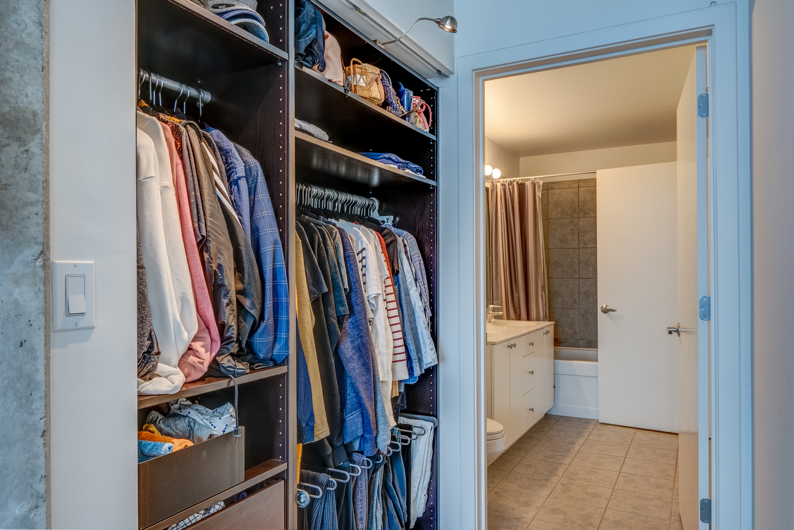 235 West Van Buren Street, Unit 3011 Chicago, IL 60607 - Photo 20 of 30 a view of walk in closet with clothes and shoes