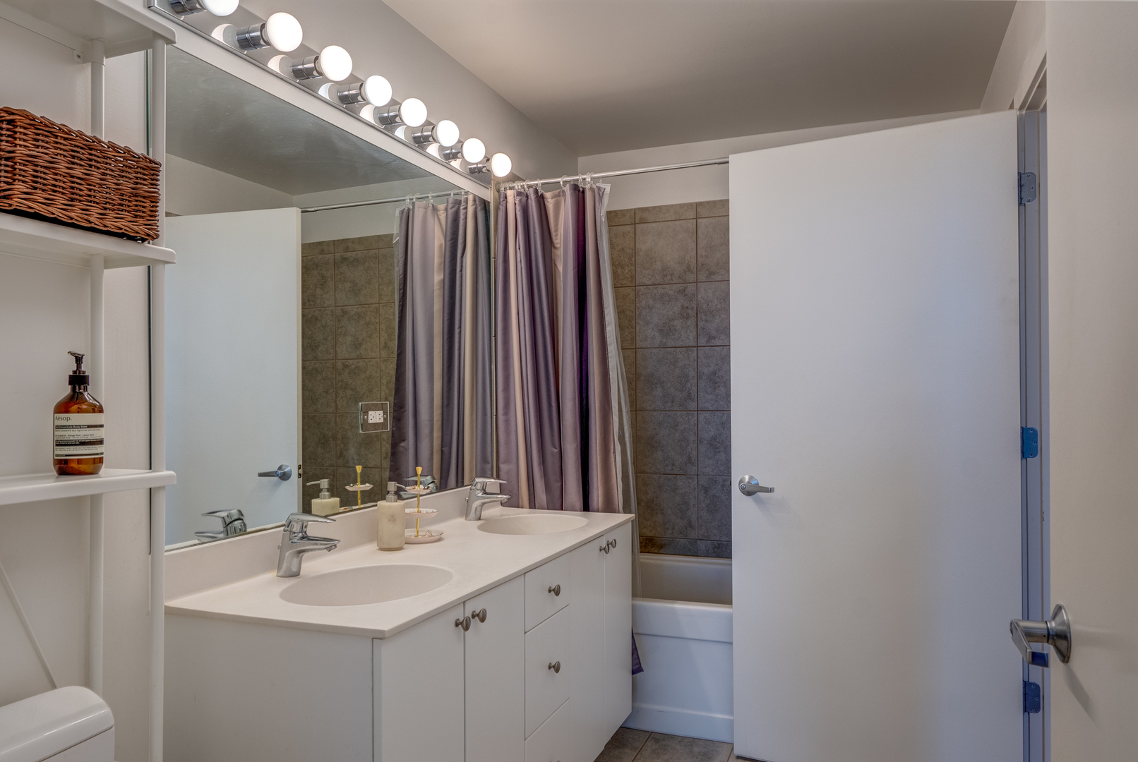 235 West Van Buren Street, Unit 3011 Chicago, IL 60607 - Photo 23 of 30 a bathroom with a double vanity sink and a mirror