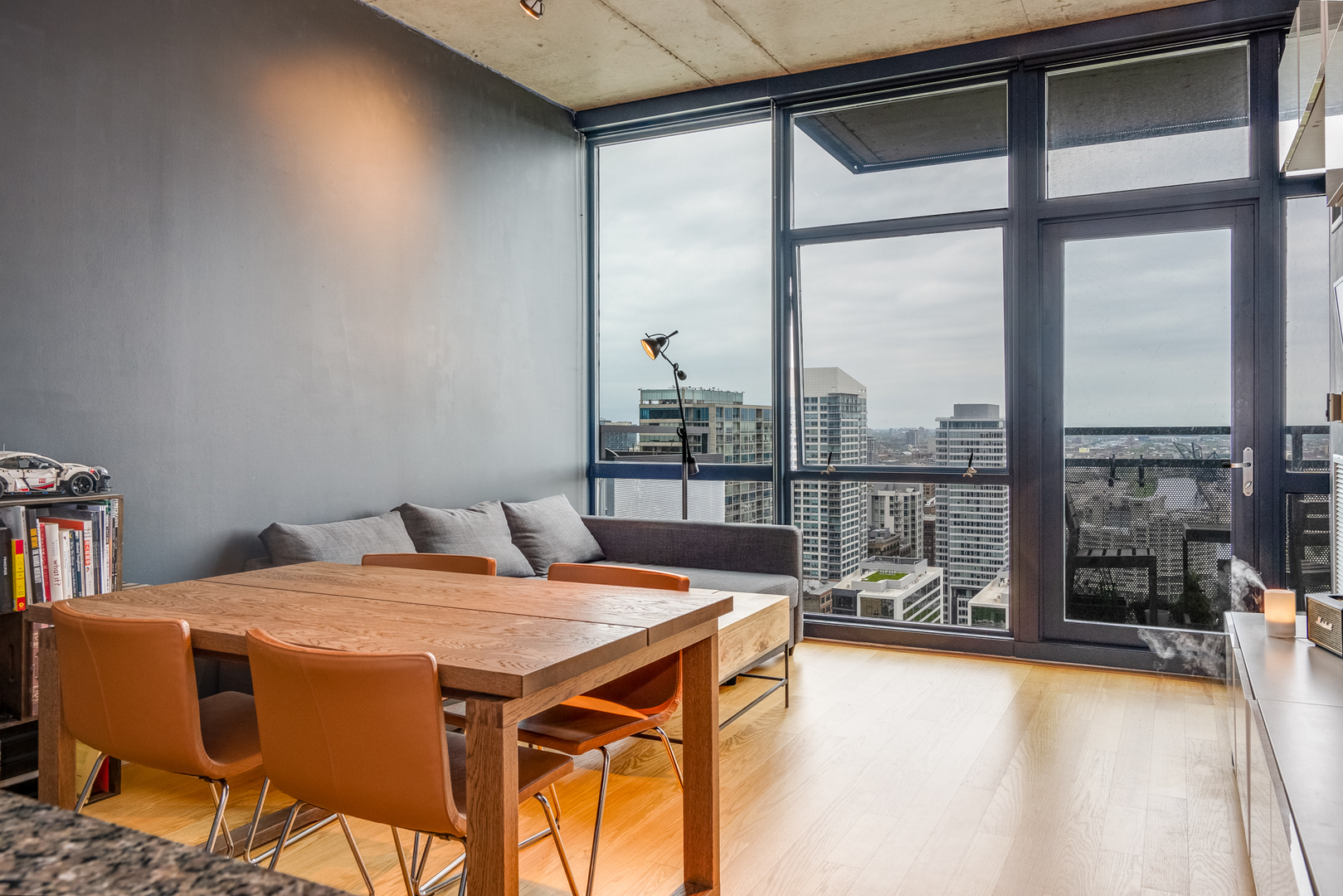 235 West Van Buren Street, Unit 3011 Chicago, IL 60607 - Photo 9 of 30 a dining room with furniture and a floor to ceiling window