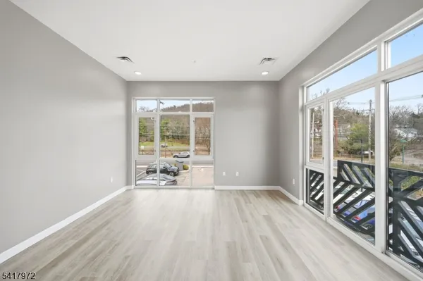 a view of a room with wooden floor and furniture