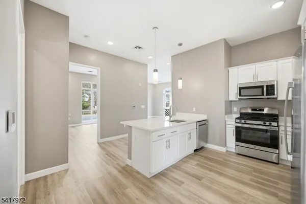 a large kitchen with a stove top oven and refrigerator