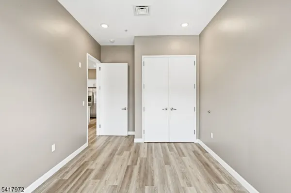 a view of hallway with wooden floor