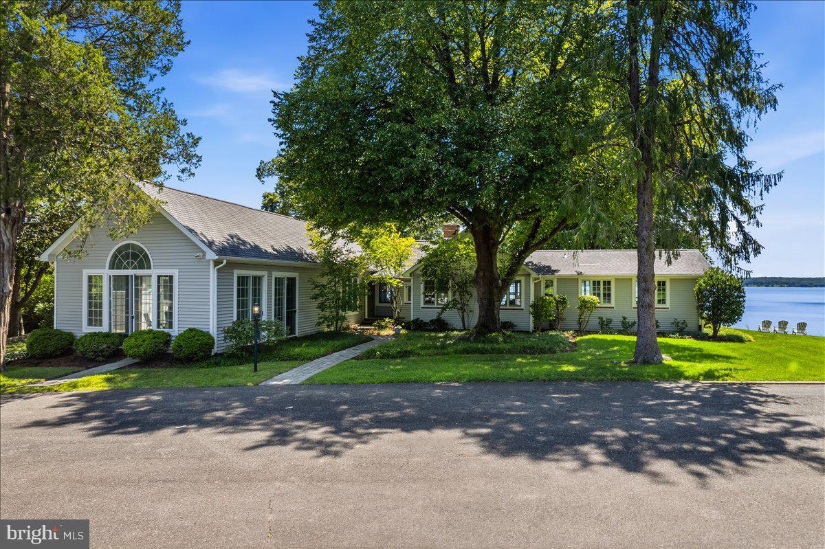 6110 Sheridan Point Road Prince Frederick, MD 20678 - Photo 16 of 77 Lakeside retreat with lush greenery.