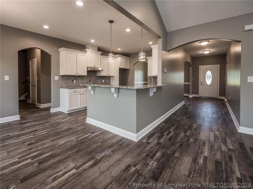 1102 West Carthage Road Lumberton, NC 28360 - Photo 13 of 41 a open kitchen with stainless steel appliances granite countertop a refrigerator and a stove