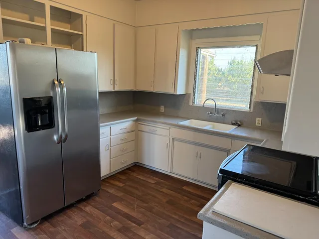 a kitchen with a refrigerator and a sink