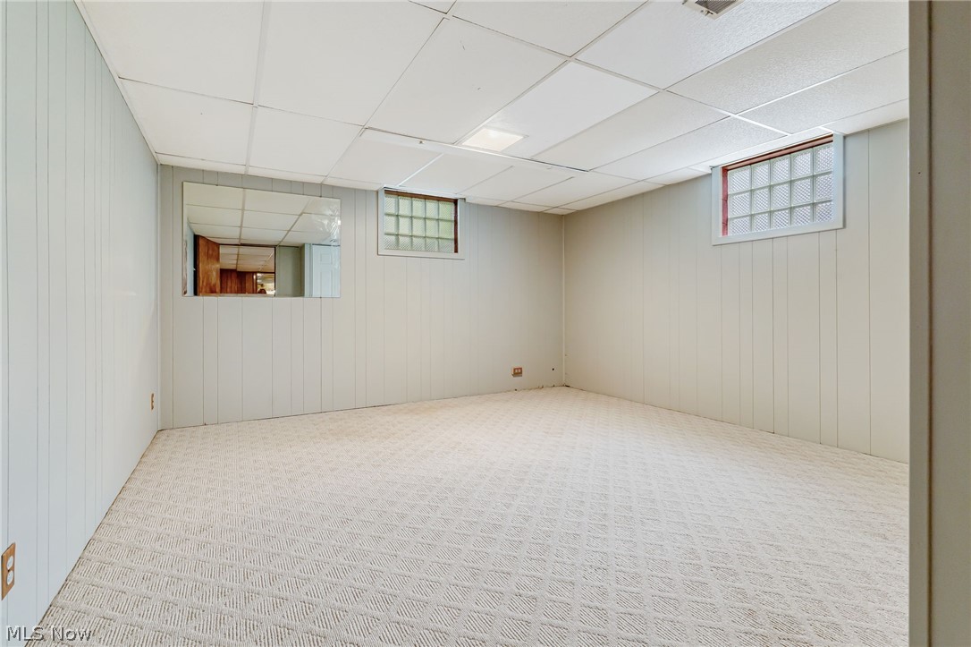1010 Knollwood Road Northwest Canton, OH 44708 - Photo 32 of 47 Basement featuring carpet and a paneled ceiling