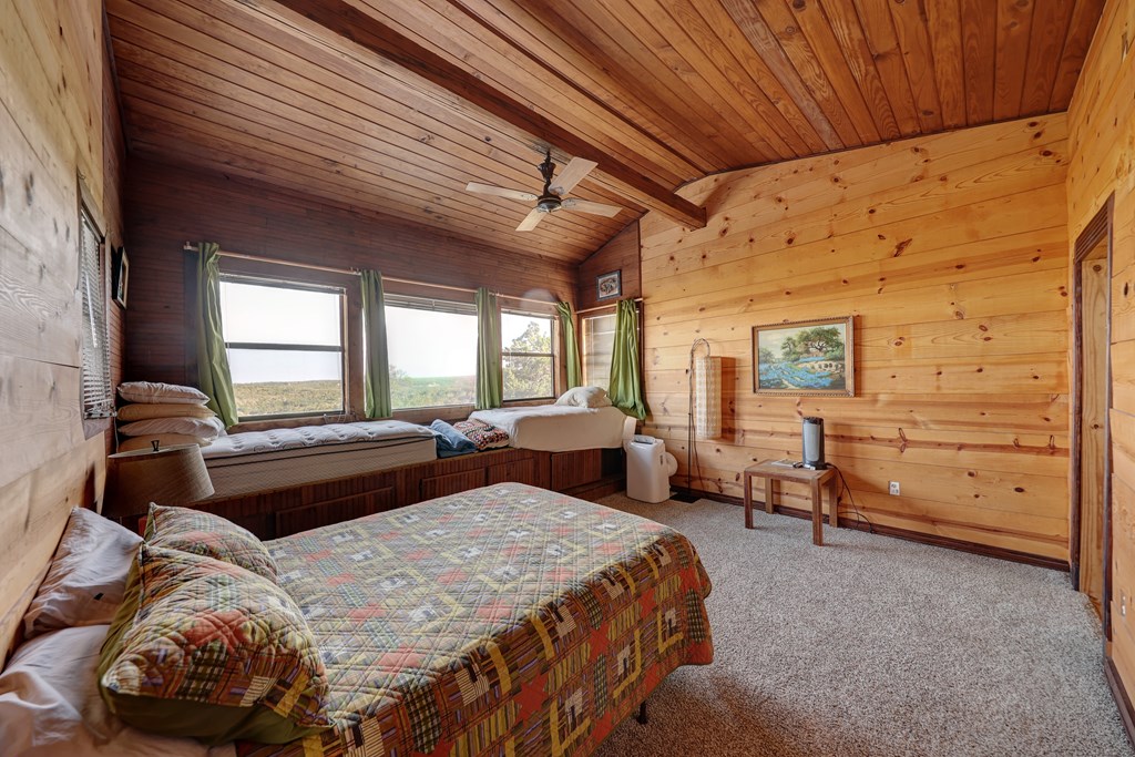 134 White Pearl Road Hunt, TX 78024 - Photo 13 of 40 a bedroom with a bed and a dresser next to a window