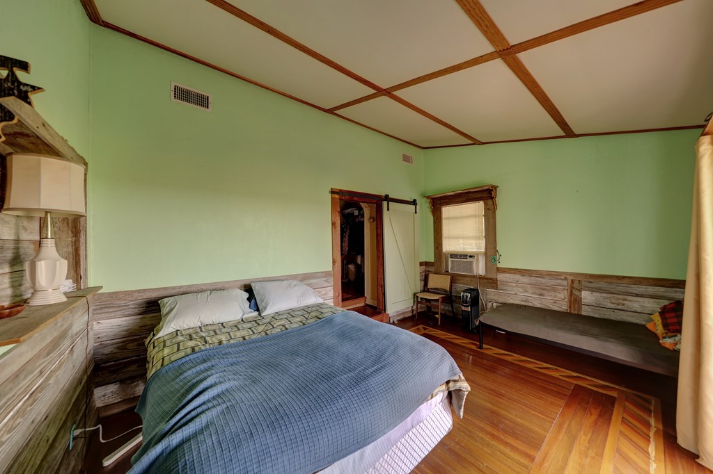 134 White Pearl Road Hunt, TX 78024 - Photo 18 of 40 a bedroom with a bed and wooden floor