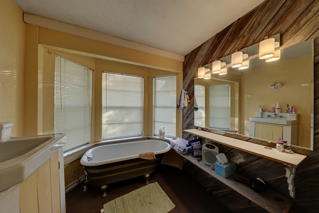 134 White Pearl Road Hunt, TX 78024 - Photo 20 of 40 a room with a large mirror and a sink