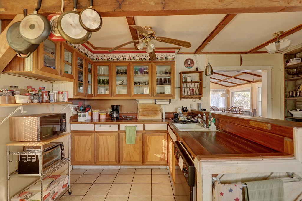 134 White Pearl Road Hunt, TX 78024 - Photo 3 of 40 a kitchen with a stove a sink and a refrigerator