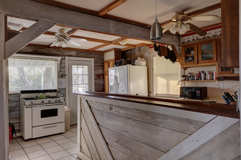 134 White Pearl Road Hunt, TX 78024 - Photo 4 of 40 a kitchen with stainless steel appliances granite countertop a stove a sink and a microwave
