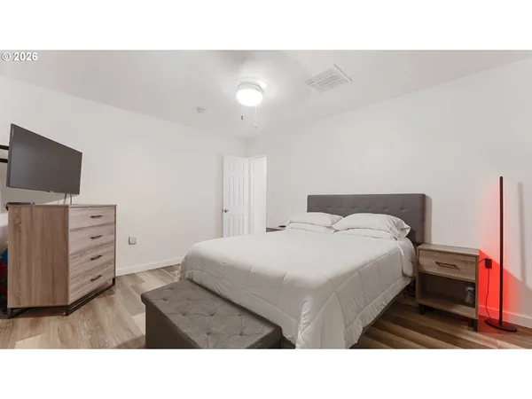 a bedroom with a bed and dresser