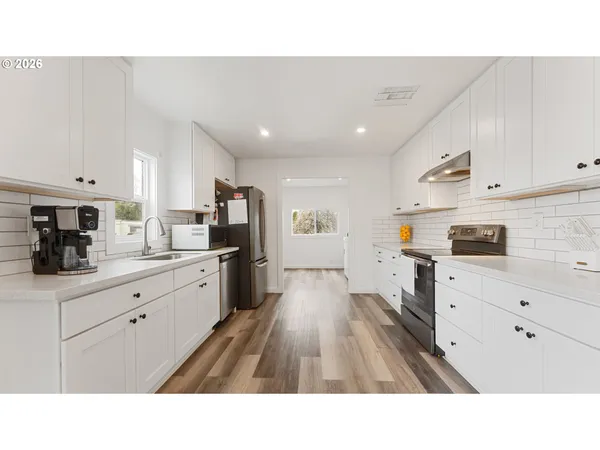 a open kitchen with cabinets stove and refrigerator