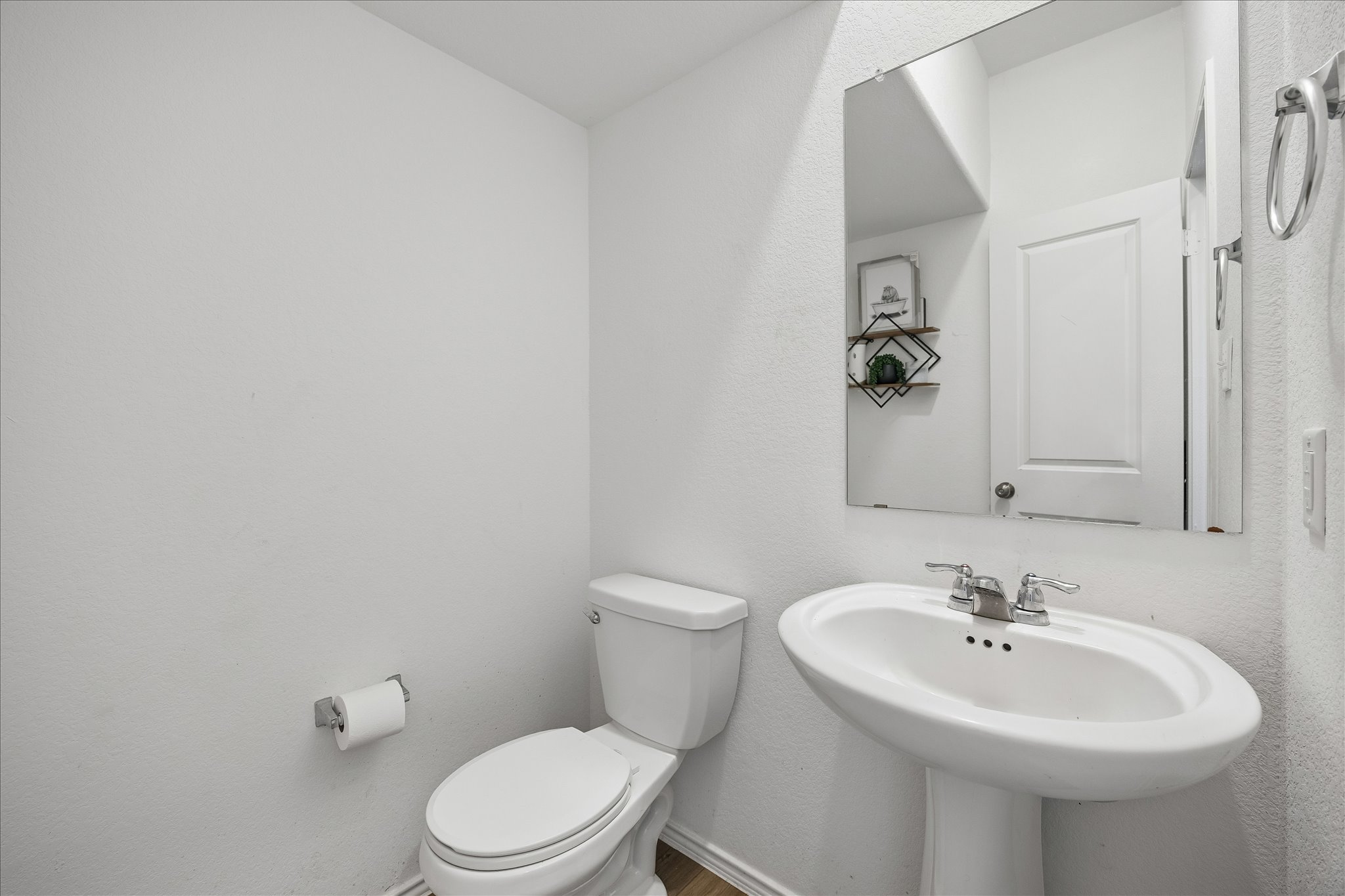 217 Canley Loop Hutto, TX 78634 - Photo 28 of 36 A pristine powder room featuring a sleek pedestal sink and a sparkling wall-mounted mirror.