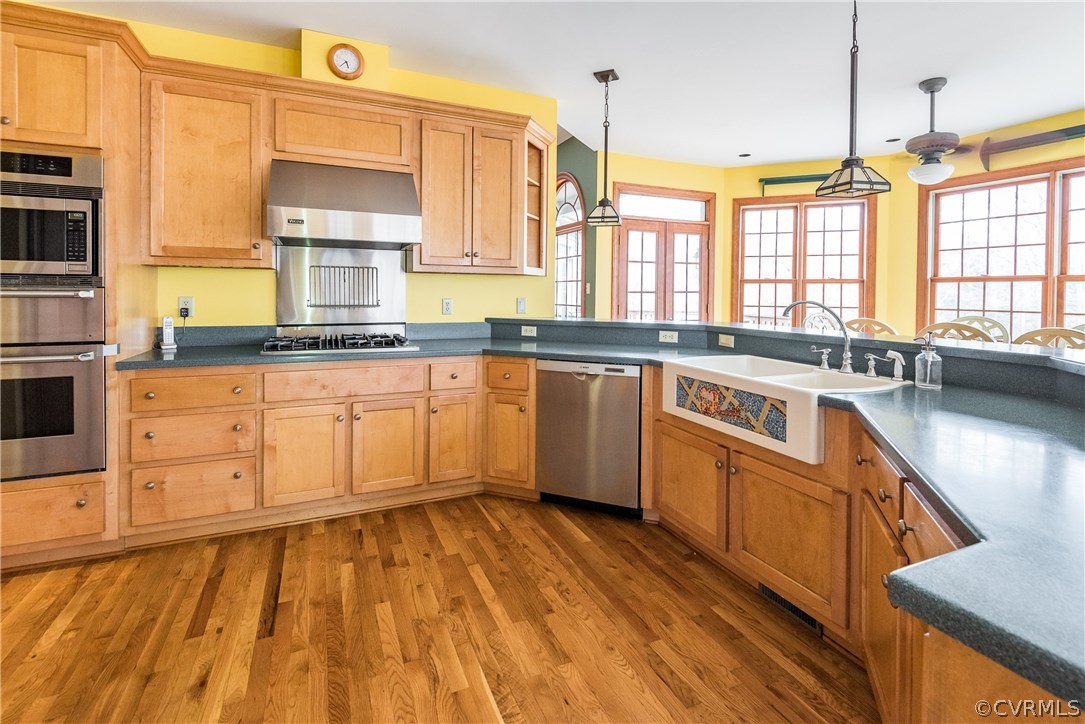 11300 Taylor Road Chesterfield, VA 23838 - Photo 13 of 39 a large kitchen with stainless steel appliances granite countertop a stove a sink and a microwave
