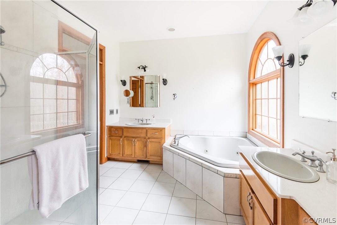 11300 Taylor Road Chesterfield, VA 23838 - Photo 20 of 39 a bathroom with a granite countertop sink a mirror a bathtub and next to a window