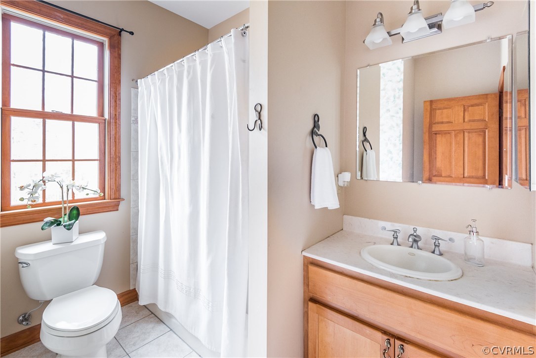 11300 Taylor Road Chesterfield, VA 23838 - Photo 23 of 39 a bathroom with a granite countertop sink toilet a mirror and a window