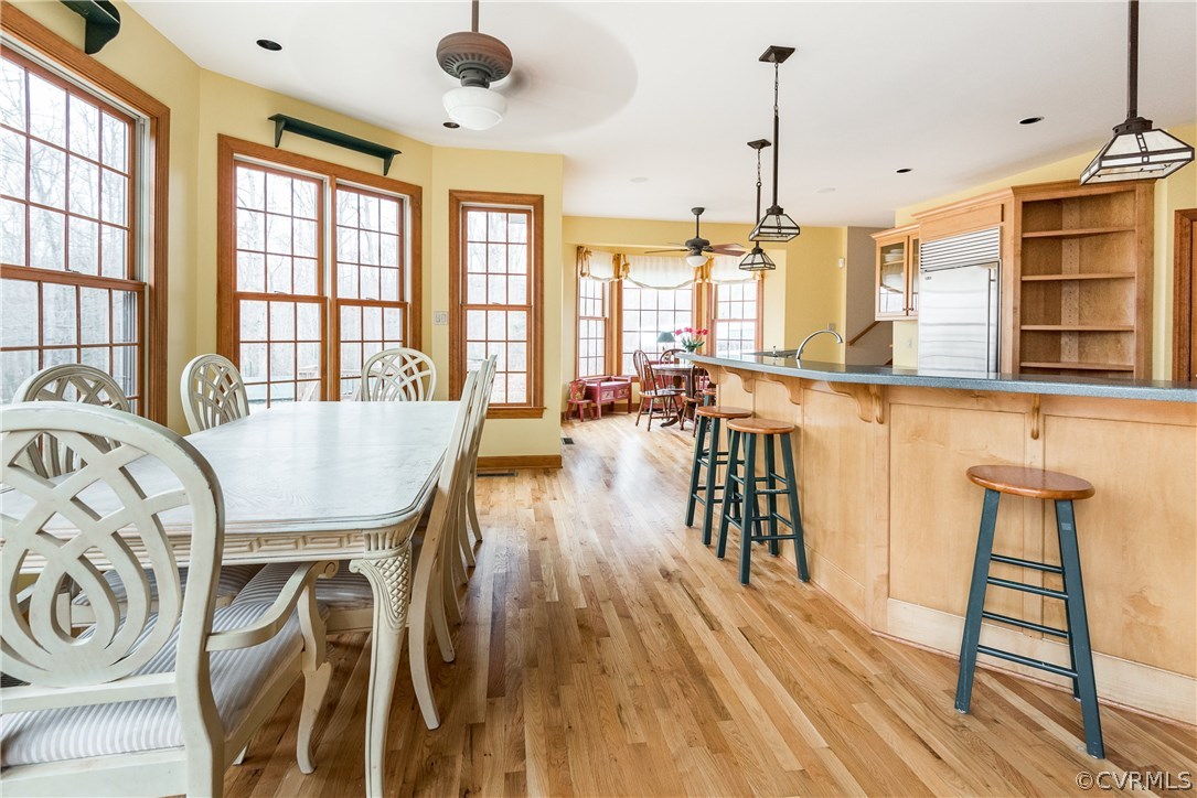11300 Taylor Road Chesterfield, VA 23838 - Photo 10 of 39 a dining room with wooden floor a chandelier a wooden table and chairs