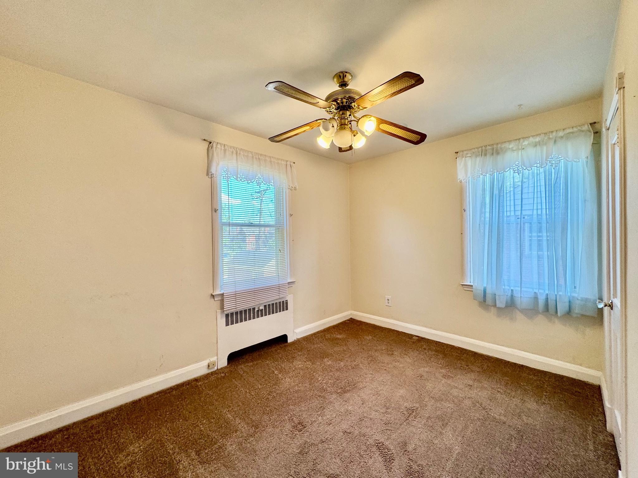 3913 Loch Raven Boulevard Baltimore, MD 21218 - Photo 18 of 38 an empty room with windows and fan