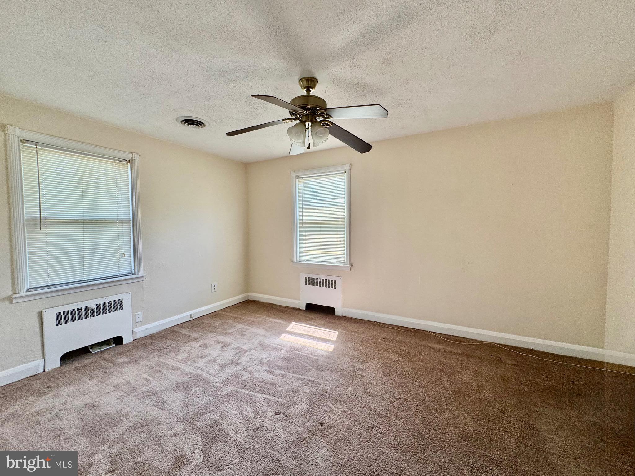 3913 Loch Raven Boulevard Baltimore, MD 21218 - Photo 19 of 38 an empty room with windows and fan