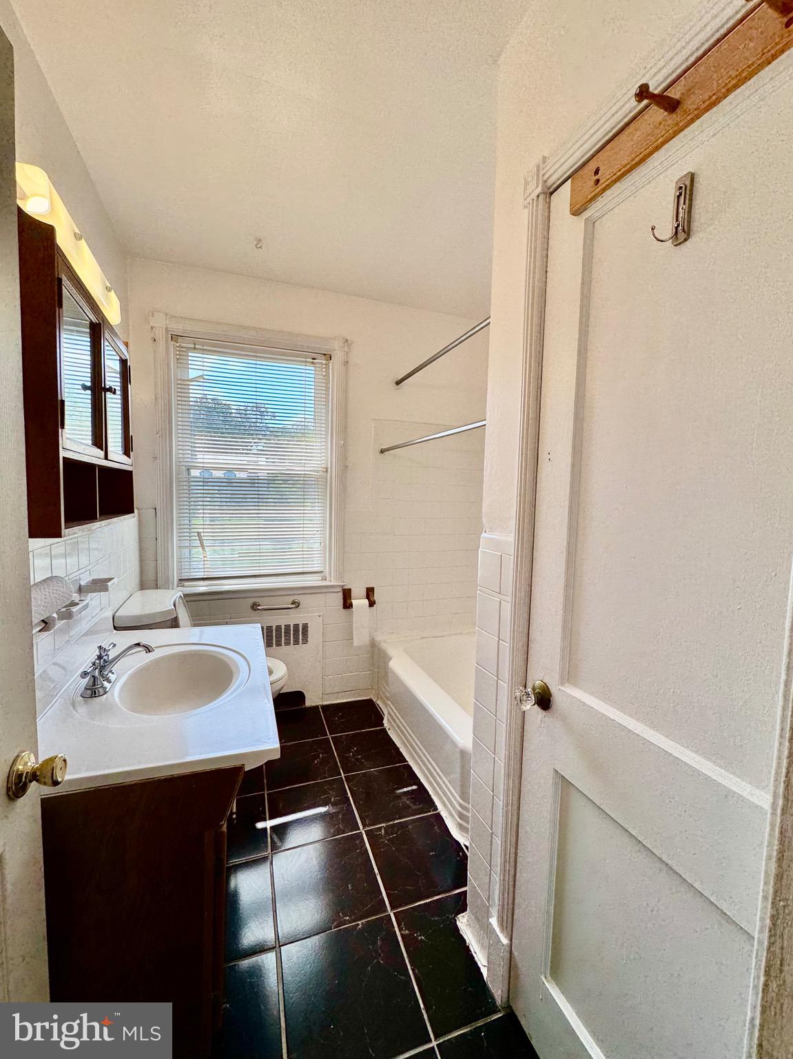 3913 Loch Raven Boulevard Baltimore, MD 21218 - Photo 20 of 38 a bathroom with a sink and a mirror