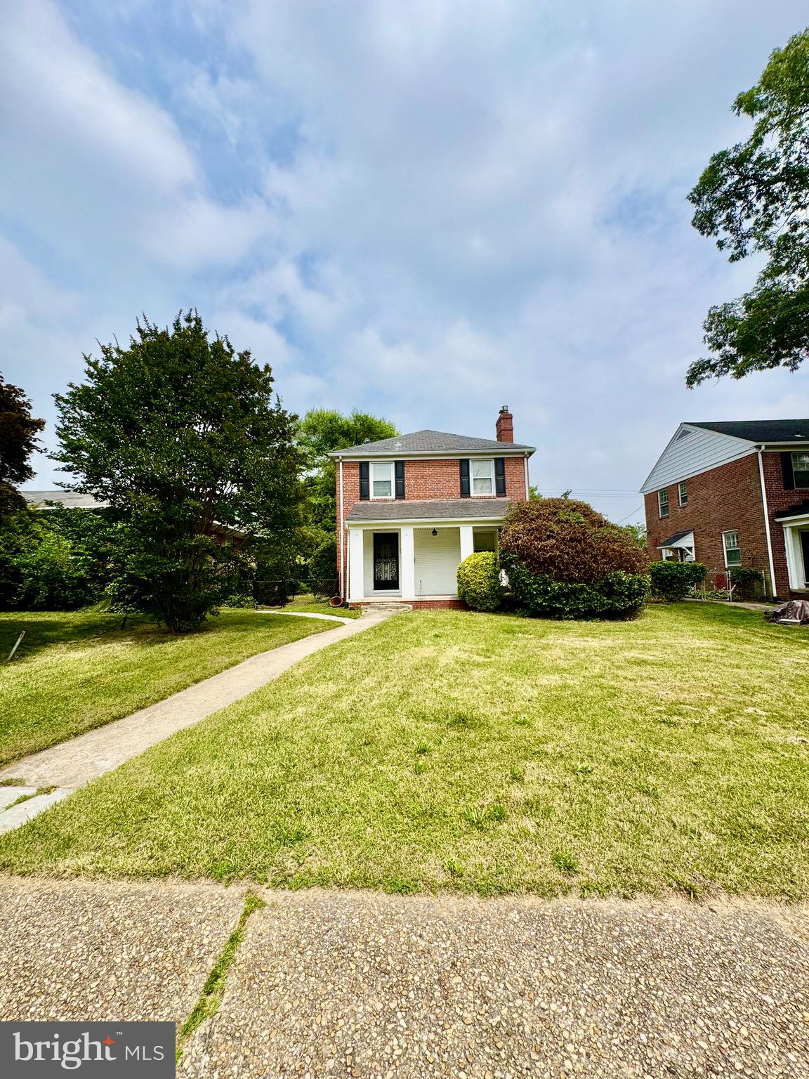 3913 Loch Raven Boulevard Baltimore, MD 21218 - Photo 2 of 38 a front view of a house with a yard