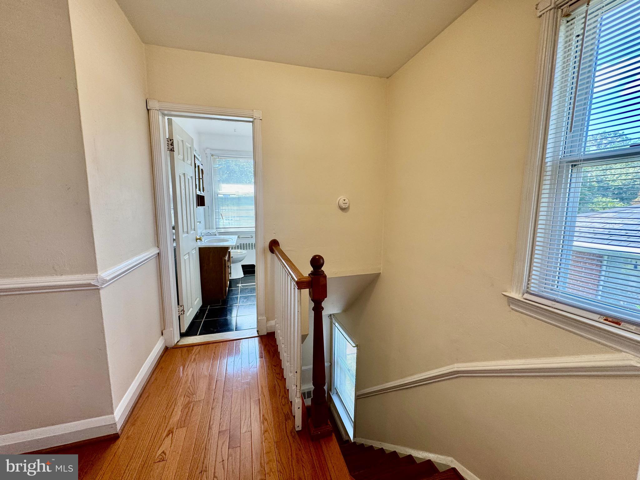 3913 Loch Raven Boulevard Baltimore, MD 21218 - Photo 21 of 38 a view of hallway with a window and wooden floor