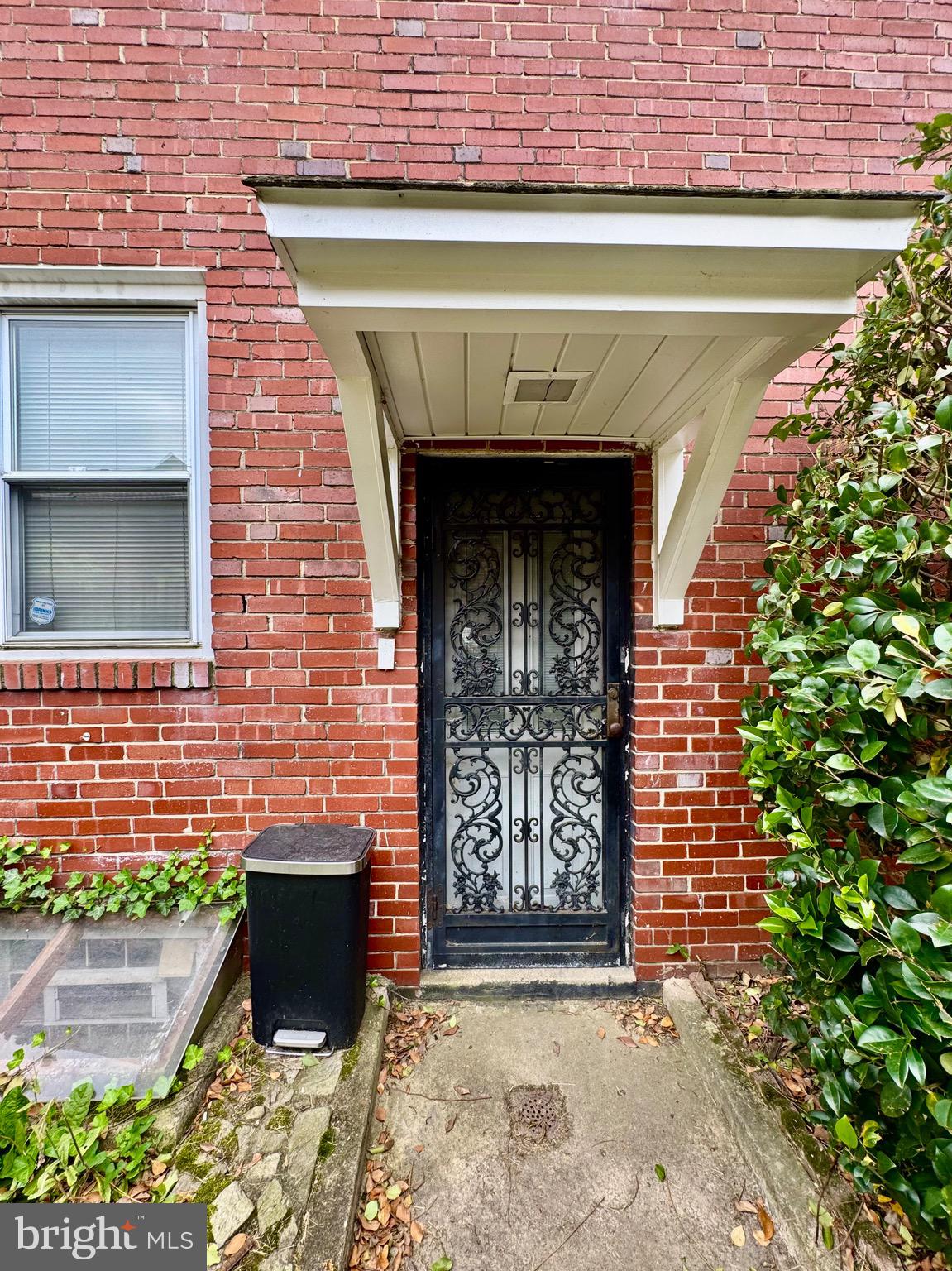 3913 Loch Raven Boulevard Baltimore, MD 21218 - Photo 25 of 38 a front view of a building with a garden and garage