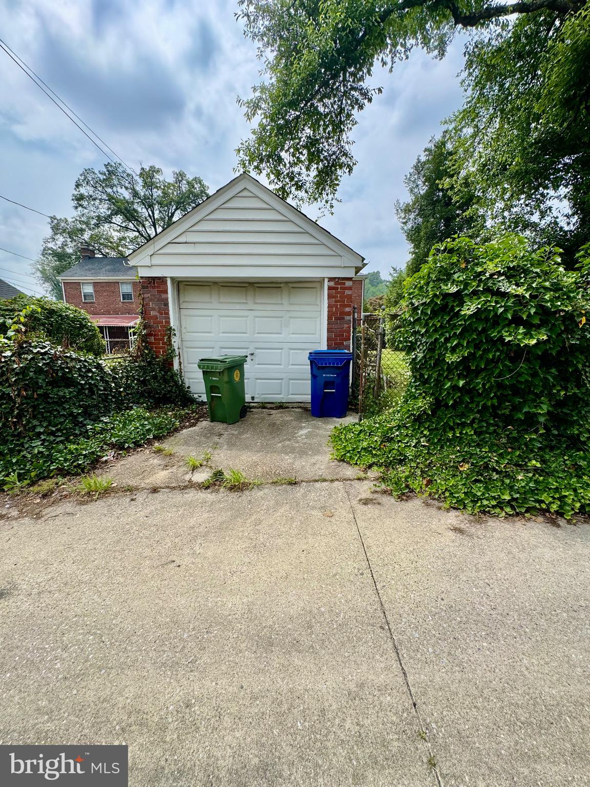 3913 Loch Raven Boulevard Baltimore, MD 21218 - Photo 29 of 38 a front view of a house with a yard and garage