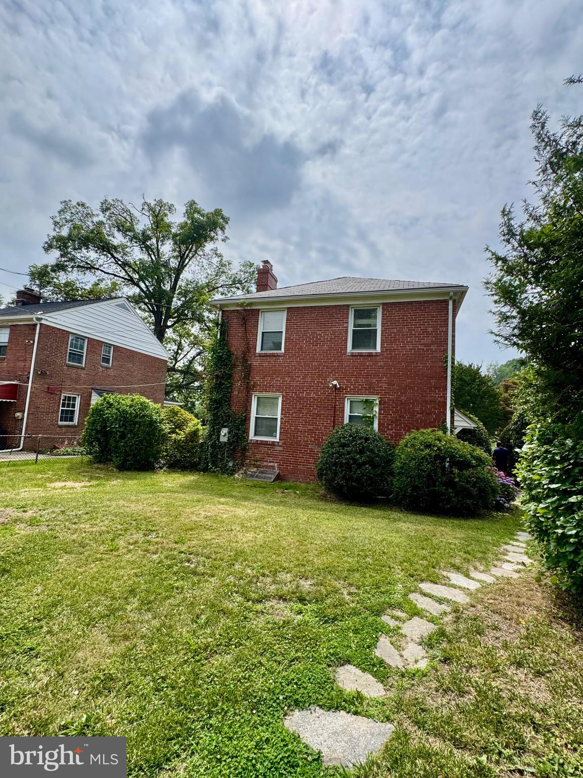 3913 Loch Raven Boulevard Baltimore, MD 21218 - Photo 33 of 38 a brick house with a yard plants and large tree