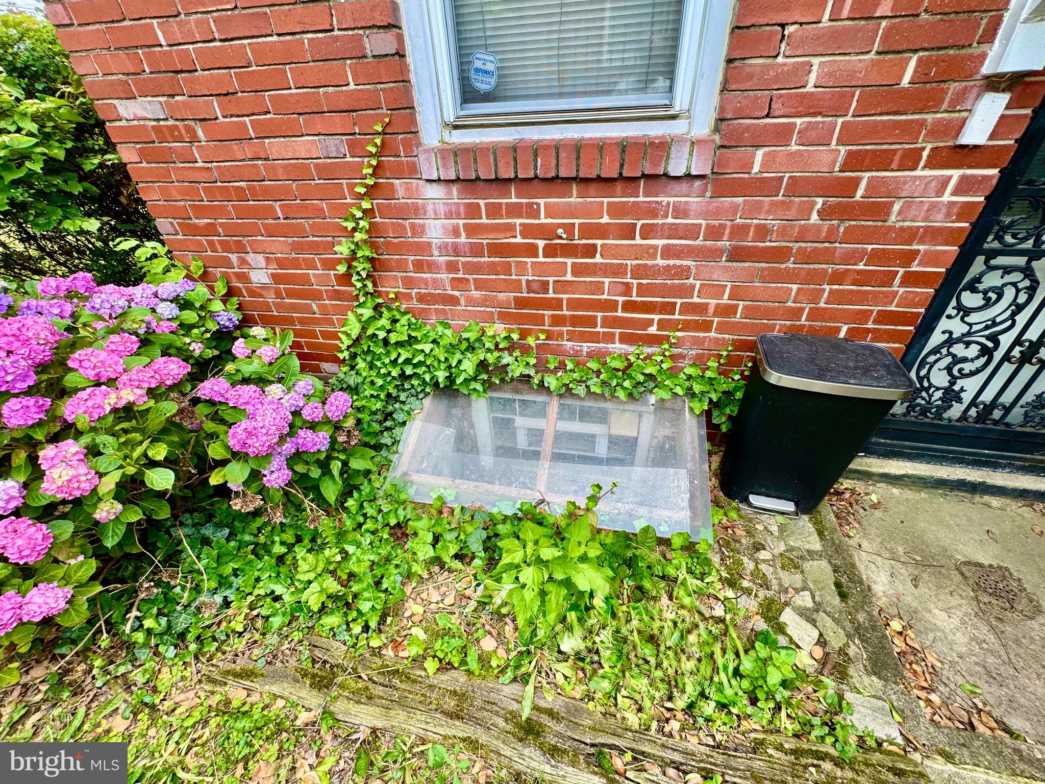 3913 Loch Raven Boulevard Baltimore, MD 21218 - Photo 36 of 38 a view of a brick house with a flower garden