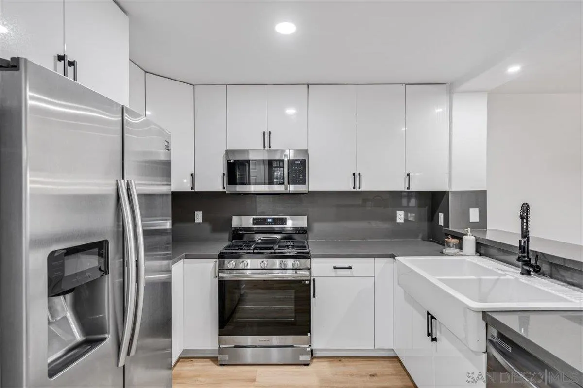 12865 Carriage Heights Way Poway, CA 92064 - Photo 13 of 42 a kitchen with stainless steel appliances a sink stove and refrigerator