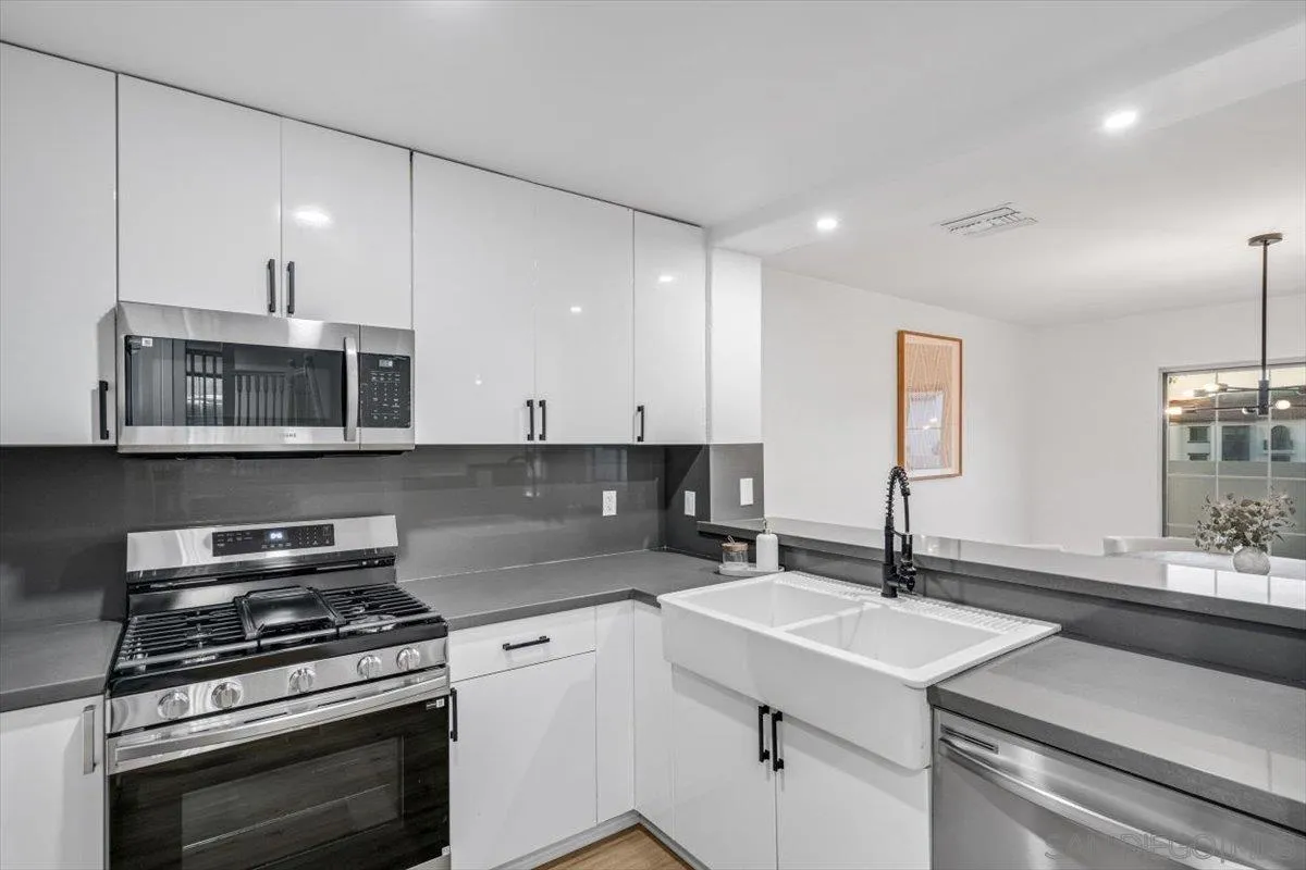 12865 Carriage Heights Way Poway, CA 92064 - Photo 14 of 42 a kitchen with a sink stove and microwave