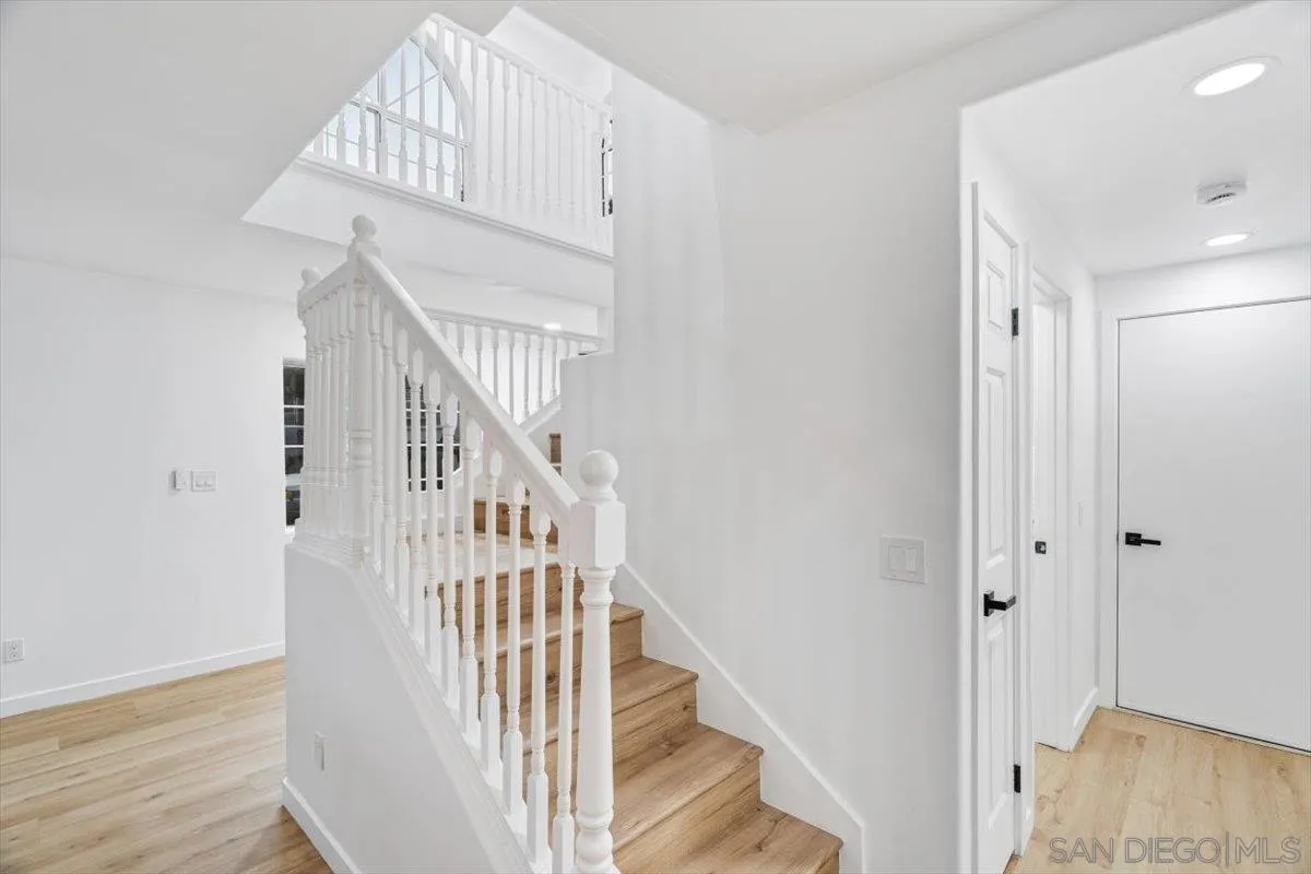 12865 Carriage Heights Way Poway, CA 92064 - Photo 17 of 42 a view of staircase with wooden floor and white walls
