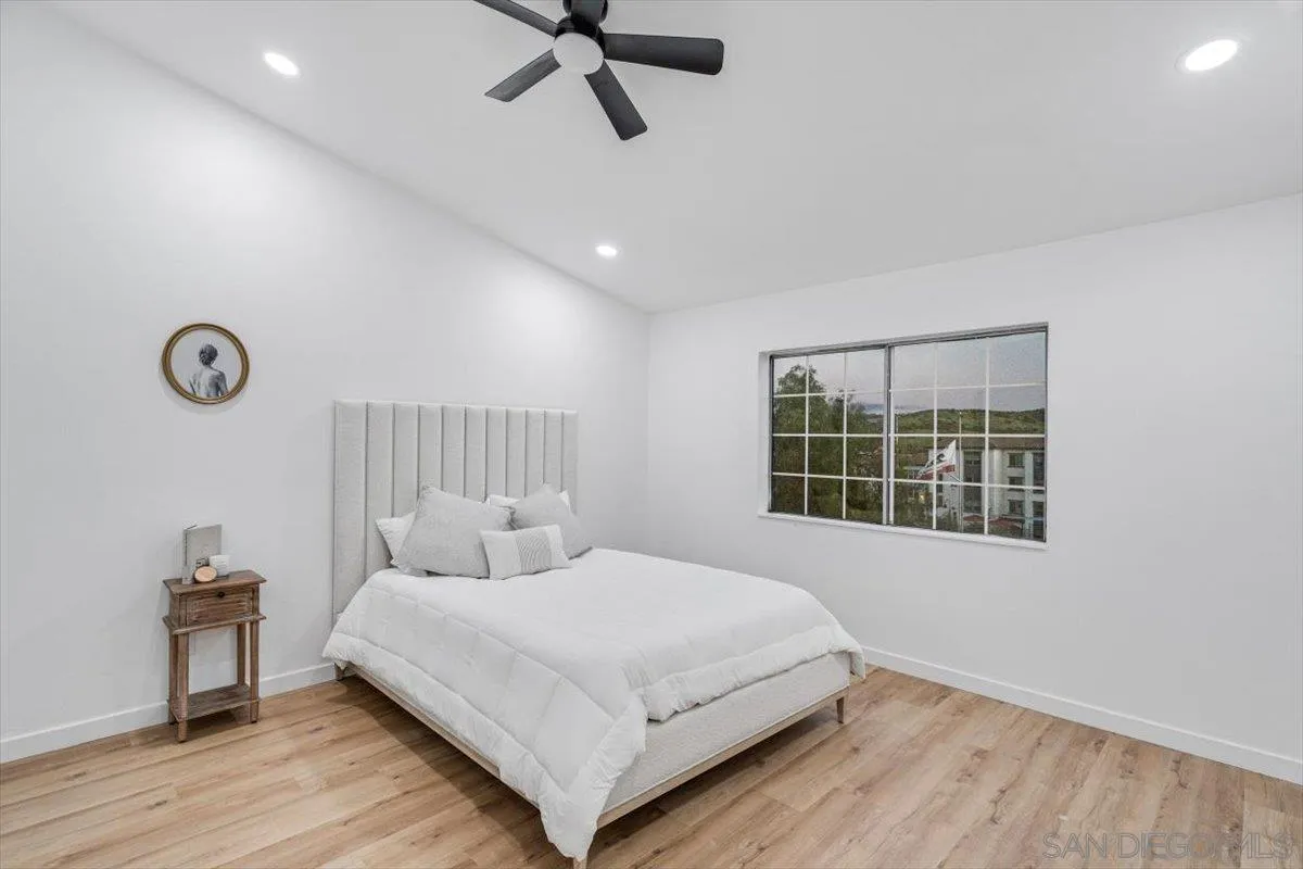 12865 Carriage Heights Way Poway, CA 92064 - Photo 22 of 42 a bedroom with a large bed and a window