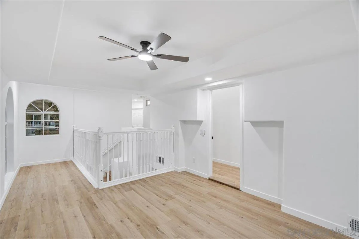 12865 Carriage Heights Way Poway, CA 92064 - Photo 25 of 42 a view of empty room with wooden floor and fan