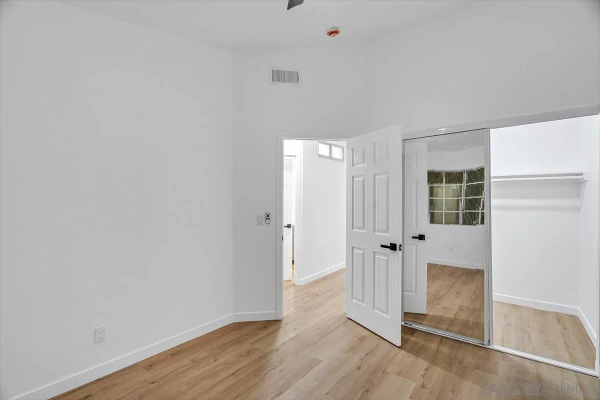 12865 Carriage Heights Way Poway, CA 92064 - Photo 29 of 42 an empty room with wooden floor and windows