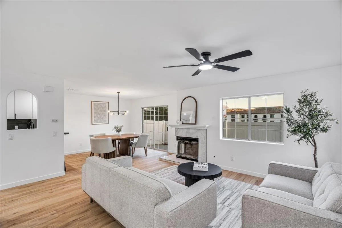 12865 Carriage Heights Way Poway, CA 92064 - Photo 7 of 42 a living room with furniture a fireplace and a large window
